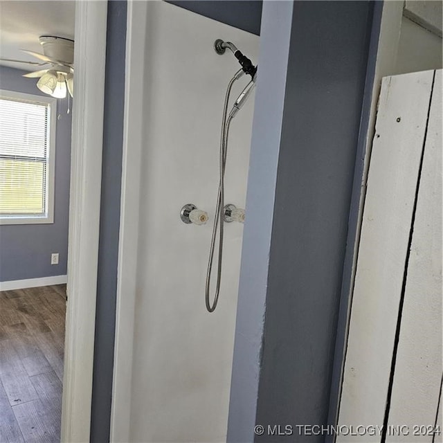 bathroom featuring ceiling fan, walk in shower, and hardwood / wood-style flooring