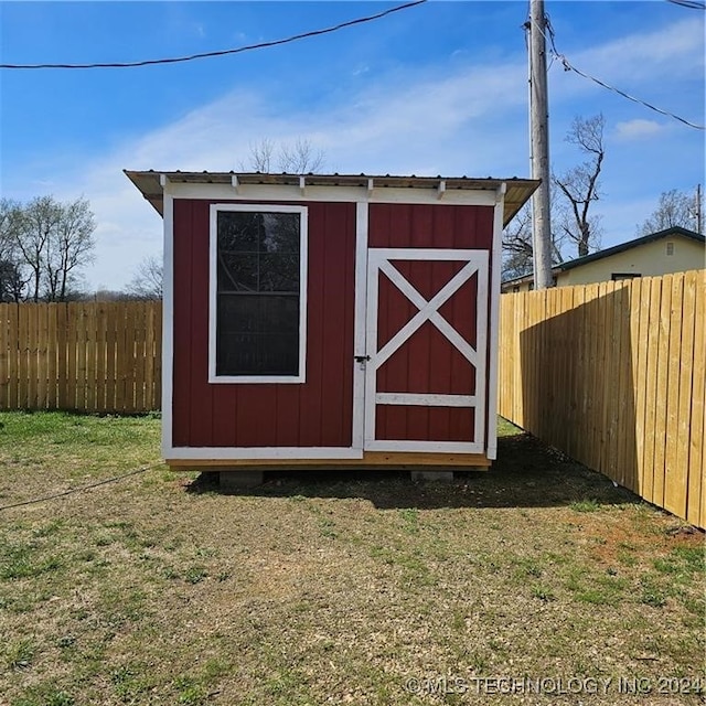 view of outdoor structure featuring a lawn