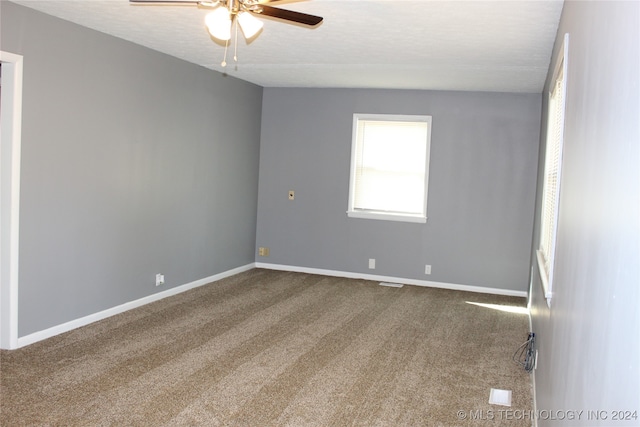 spare room with carpet floors, a textured ceiling, and ceiling fan