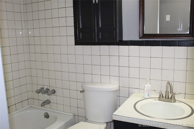 full bathroom with tile walls, tasteful backsplash, vanity, tiled shower / bath combo, and toilet