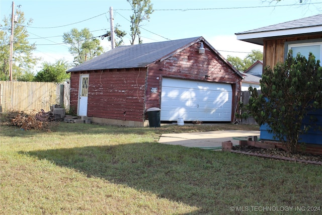 garage featuring a lawn