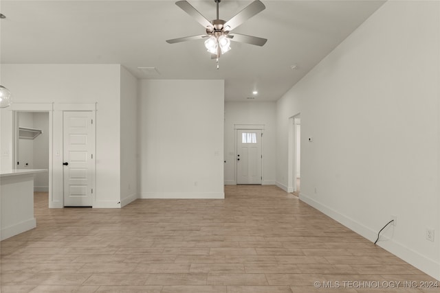 empty room featuring light hardwood / wood-style flooring and ceiling fan