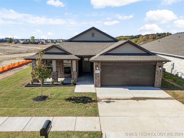 view of front of home featuring a front lawn and a garage