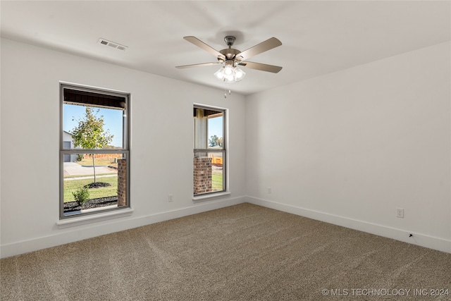 spare room featuring ceiling fan and carpet floors