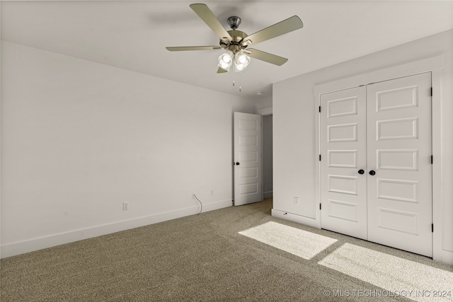 unfurnished bedroom with a closet, ceiling fan, and carpet floors