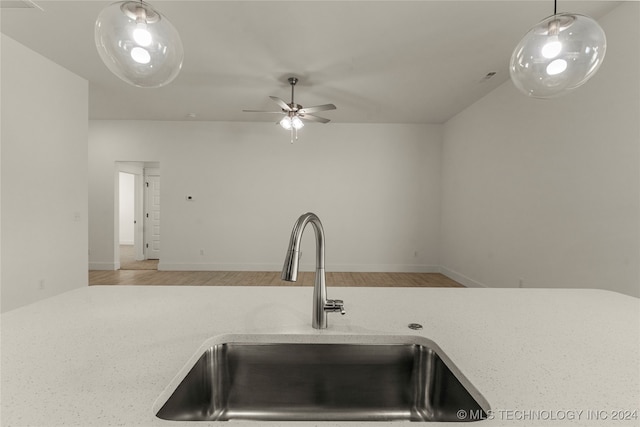 kitchen with ceiling fan, light hardwood / wood-style flooring, sink, and hanging light fixtures