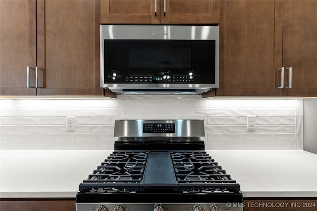 details featuring appliances with stainless steel finishes and tasteful backsplash