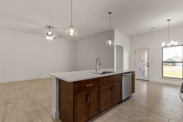 kitchen with sink, an island with sink, dishwasher, and light wood-type flooring