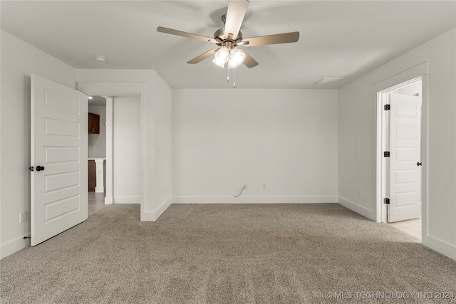 empty room featuring light carpet and ceiling fan