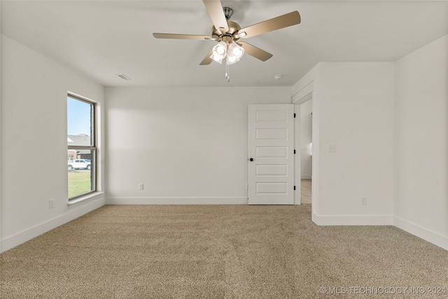 empty room with ceiling fan and carpet