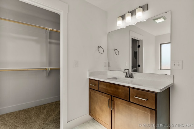 bathroom featuring vanity and a shower with door