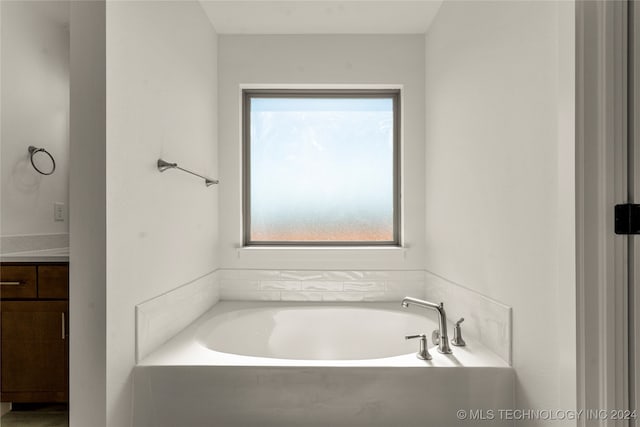 bathroom featuring vanity and a tub