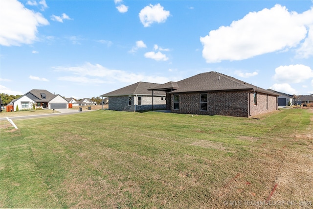 rear view of house with a lawn