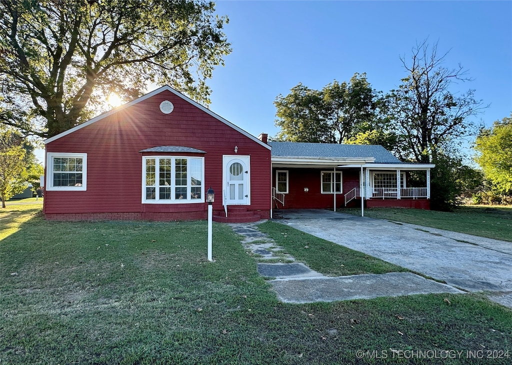 single story home with a porch and a front yard