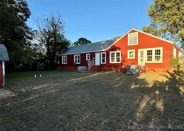 back of property with a lawn