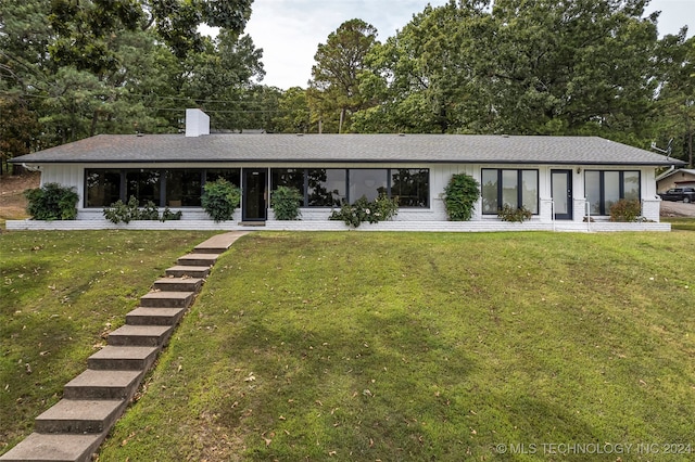 ranch-style home with a front lawn