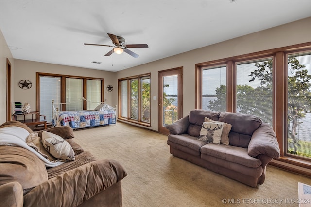 bedroom featuring ceiling fan, light colored carpet, and access to outside