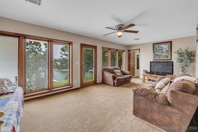 carpeted living room featuring ceiling fan