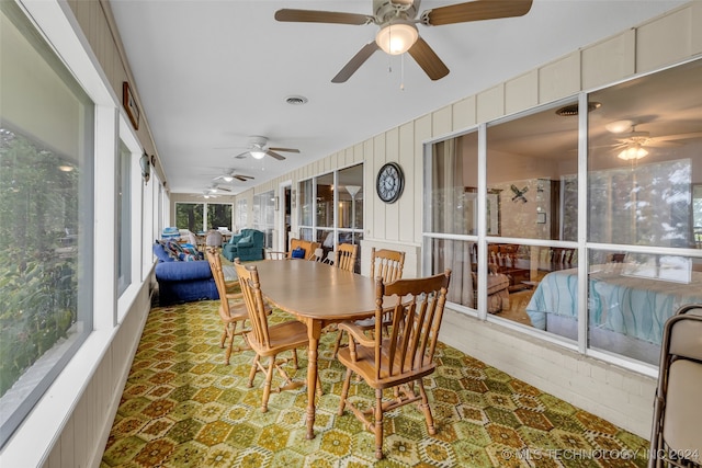 sunroom featuring ceiling fan