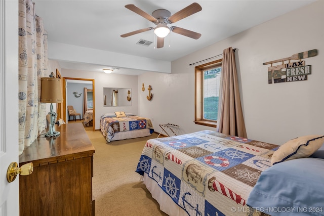 bedroom with light carpet and ceiling fan