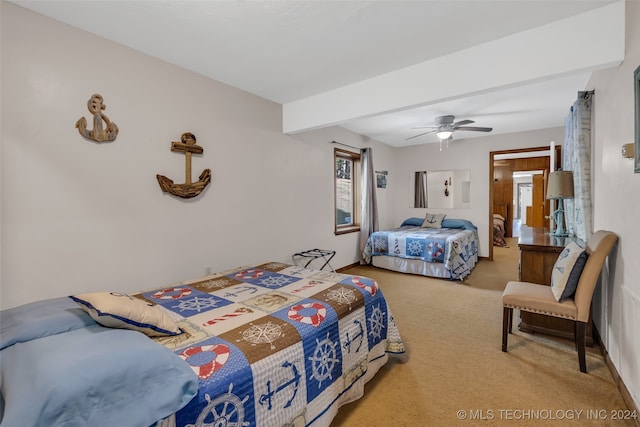 carpeted bedroom featuring ceiling fan and beamed ceiling