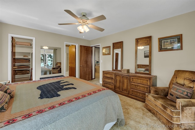 carpeted bedroom featuring ceiling fan and connected bathroom