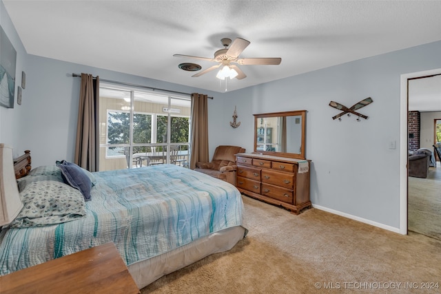 bedroom featuring ceiling fan, a textured ceiling, and light carpet