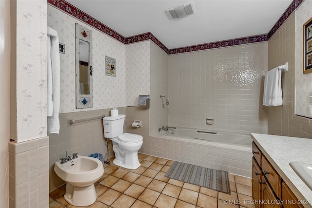 full bathroom featuring tile walls, tile patterned flooring, a bidet, vanity, and toilet