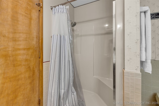 bathroom with tile walls