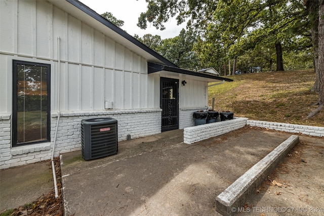 view of side of home featuring central AC unit