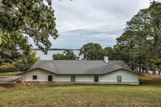 view of home's exterior featuring a water view and a yard