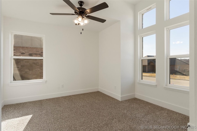 carpeted spare room with ceiling fan