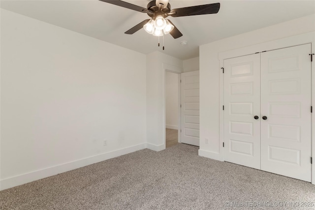 unfurnished bedroom featuring ceiling fan, carpet, and a closet