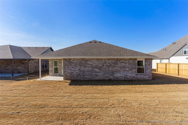 rear view of property with a patio area and a lawn