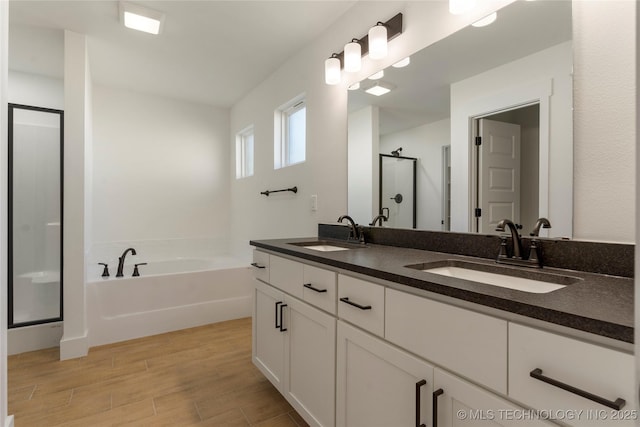 bathroom featuring independent shower and bath and vanity