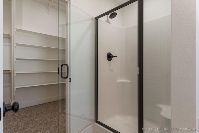 bathroom with a shower with door