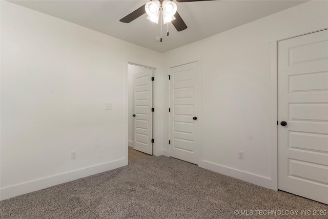 unfurnished bedroom with ceiling fan and carpet