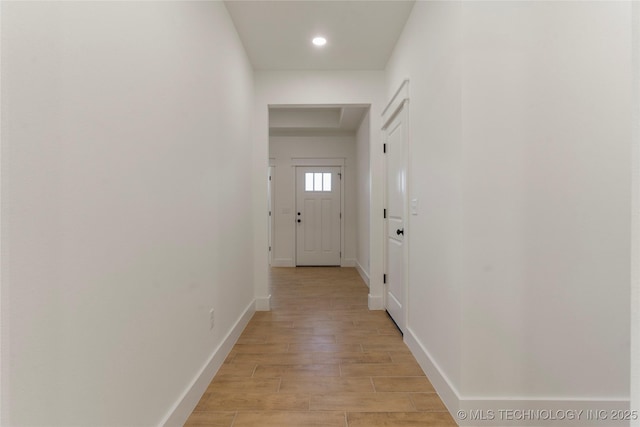 corridor with light hardwood / wood-style flooring