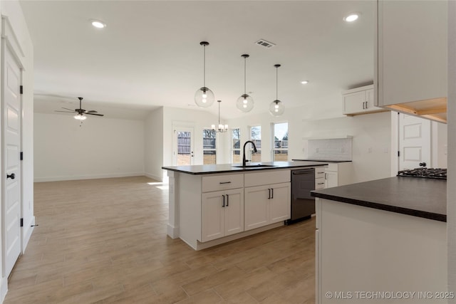 kitchen featuring sink, ceiling fan with notable chandelier, white cabinetry, and a center island with sink