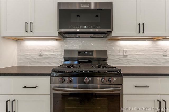 kitchen with backsplash, white cabinetry, and appliances with stainless steel finishes