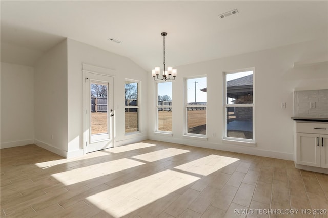 unfurnished dining area with vaulted ceiling and a chandelier