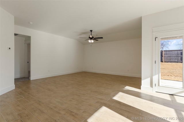 unfurnished living room with ceiling fan and vaulted ceiling