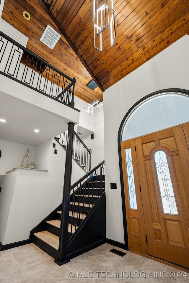 foyer featuring high vaulted ceiling and wooden ceiling