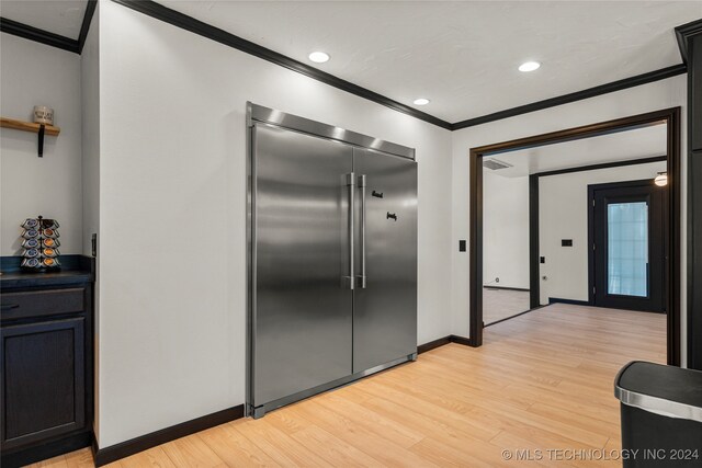 corridor featuring crown molding and light hardwood / wood-style flooring