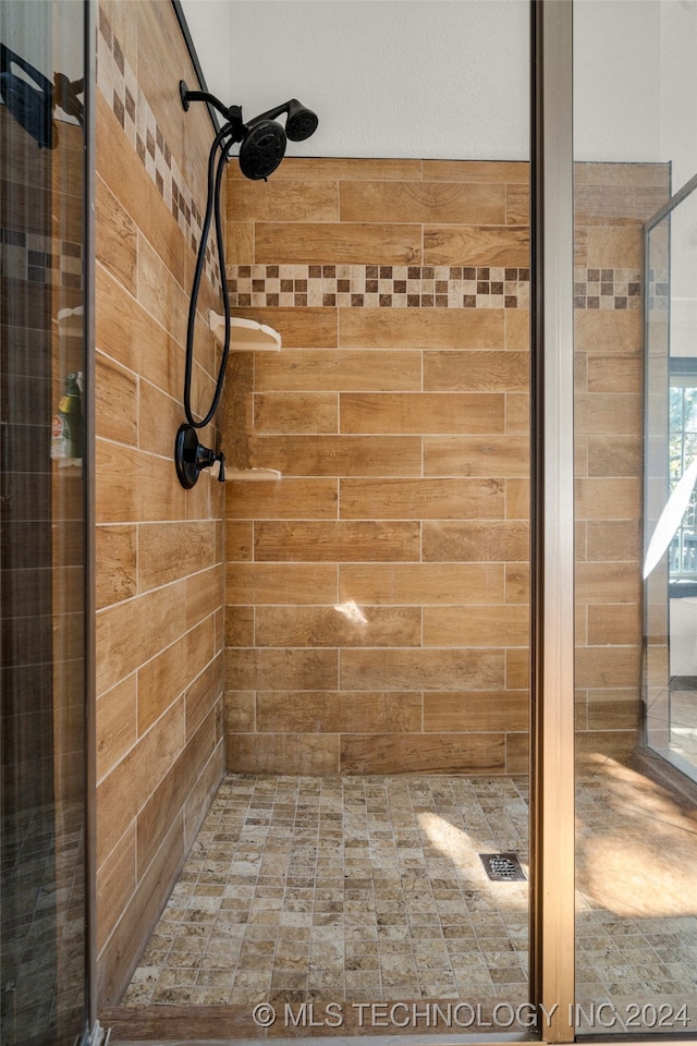 bathroom featuring a shower with door