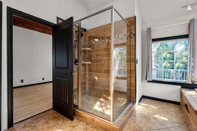 bathroom with walk in shower, lofted ceiling, vanity, and hardwood / wood-style flooring