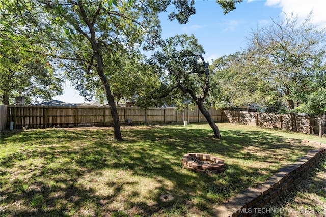 view of yard with an outdoor fire pit