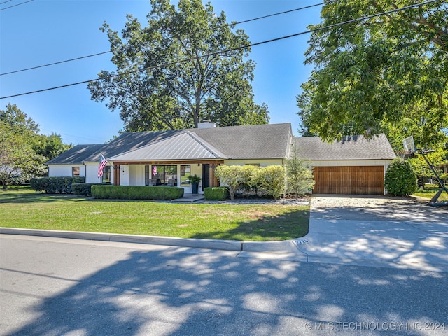 ranch-style house with a front yard and a garage