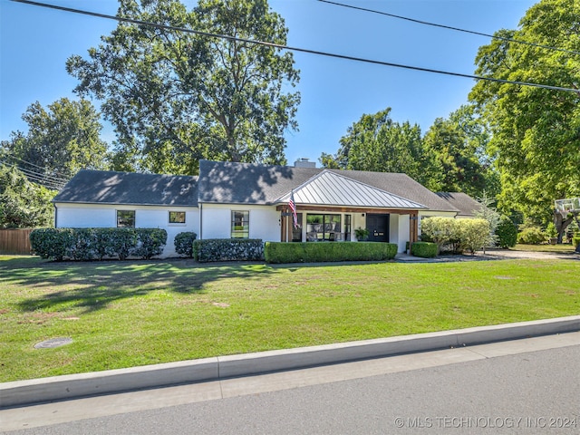 ranch-style house with a front lawn