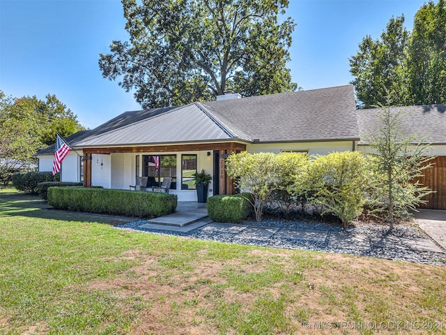 ranch-style home with a front yard and a porch